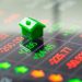 A green toy house sits on a digital financial screen displaying red and green stock numbers and arrows, symbolizing Real Estate ROI. | RealEstateMarket
